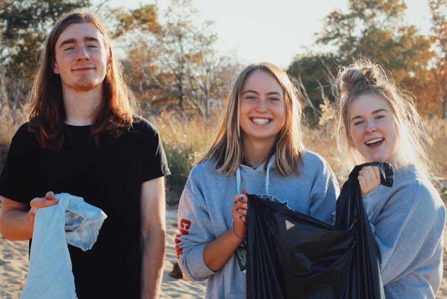 Members of the Adventure Society, a student club, clean up a beach on Kent Island. 