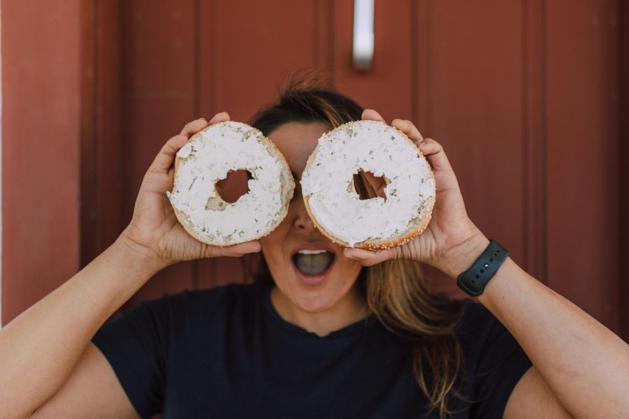 Girl holding donuts to her eyes