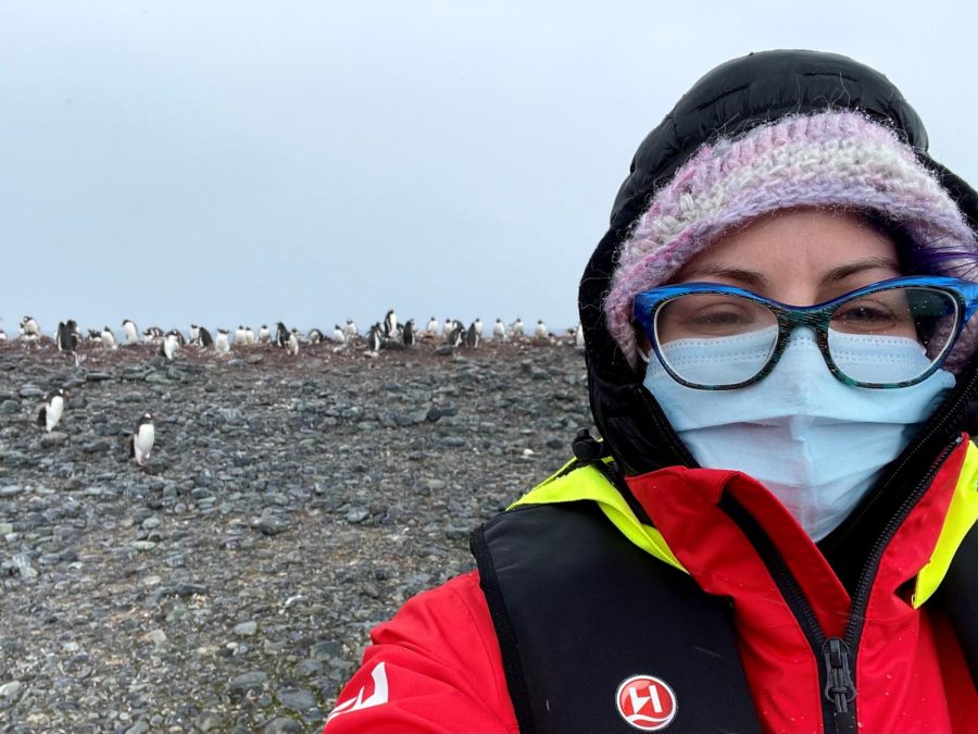Electrical engineering student Elise Porcelli, the co-president of the Super Science Club, poses with a colony of penguins while on a trip to Antarctica. 