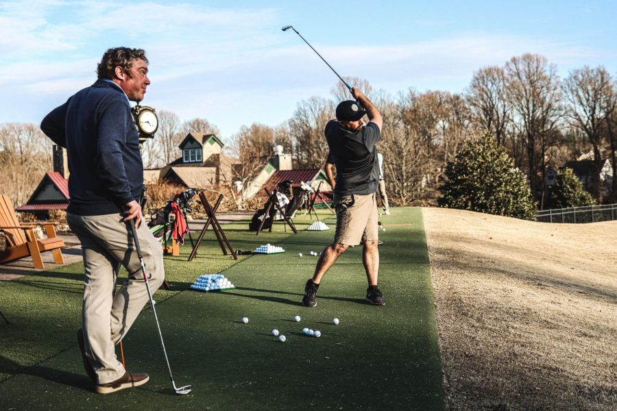  First-year golf coach Dave O’Donnell (left) prepares second-year business administration student David Henderson for the upcoming golf season.
