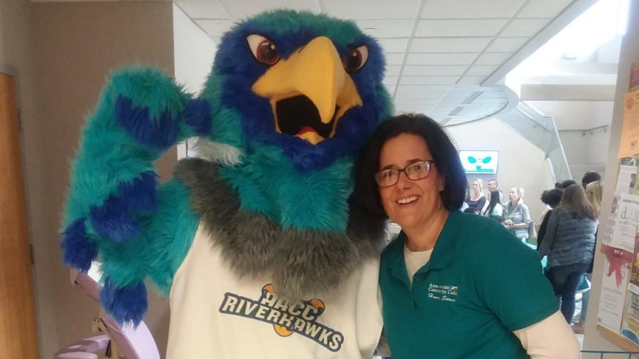 AACCs rep to the Gun Violence Intervention Task Force poses next to Swoop, the college mascot.