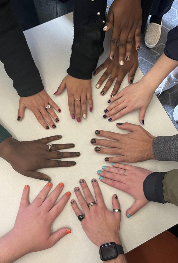 Students show off their polished fingernails at an event about self-care on campus.