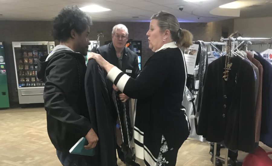 The Legal Studies Institute at AACC hosts a pop-up closet to offer students donated outfits they can wear to job interviews and work. Shown fifth-year legal studies student Gary Deleaver tries on a jacket.