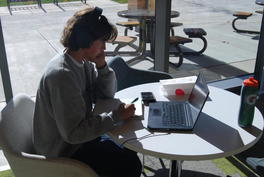 First-year computer science student Chris Sutphin studying with headphones on.