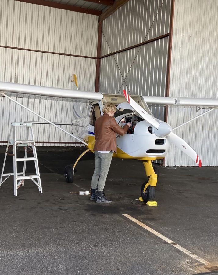 Second-year communications student Jenna Lagoey, who earned a pilot's license in 2021, prepares a Tecnam P92 plane for takeoff. 