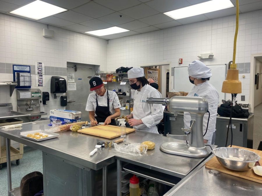 Baking and pastry arts student Laurie Boucher (left) teaches a pasta-making demonstration on Dec. 1.