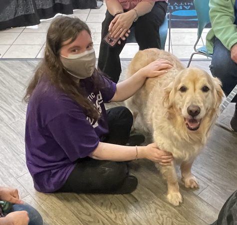 First-year humanities student Ariel Webster relaxes with a therapudic service dog provided by the nonprofit Pets on Wheels.