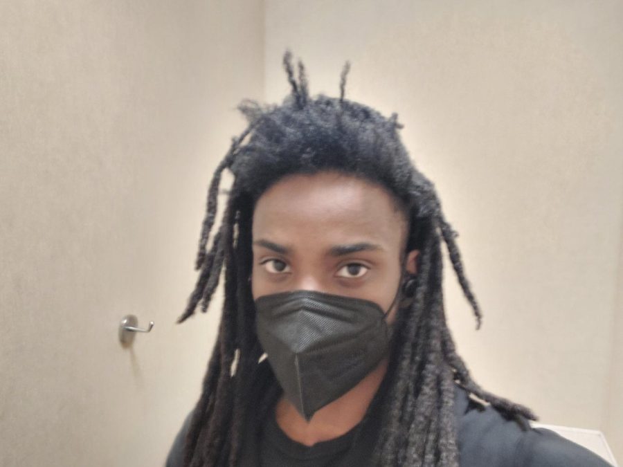 Fourth-year photography student Graig Bracey says wearing a mask helps with his allergies.