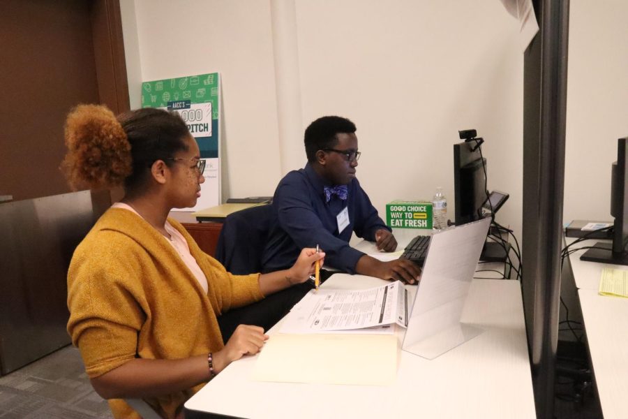 Keisha Rivera (Left) and Michael Amwoga help community members file tax returns for free.