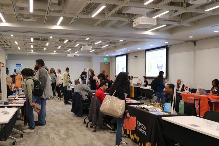 Students speak with college representatives at a transfer fair on Thursday. 