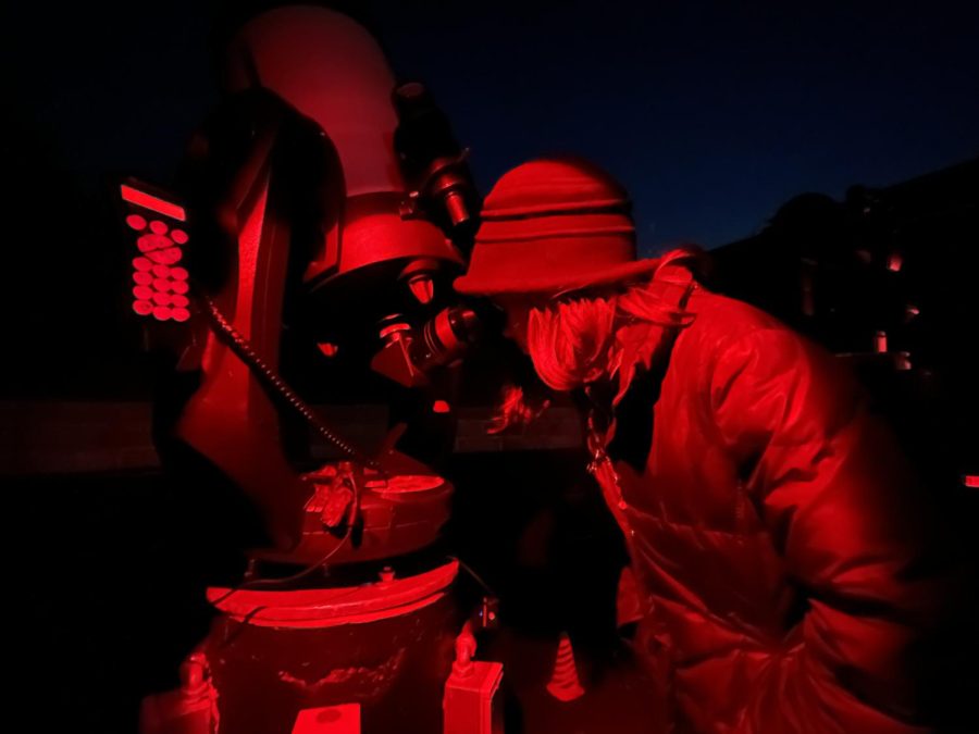 Second-year astronomy student Zoe Brunton uses a telescope at a comet viewing party on Saturday. 