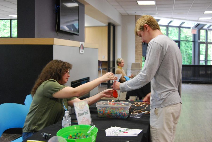 First-year film studies student Briggs Phillips, right, makes a stress ball at the Stress Less Festival on Wednesday. 