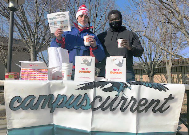 Dan Elson, left, and Frank Fitzgeralde Libom represent Campus Current on the quad.