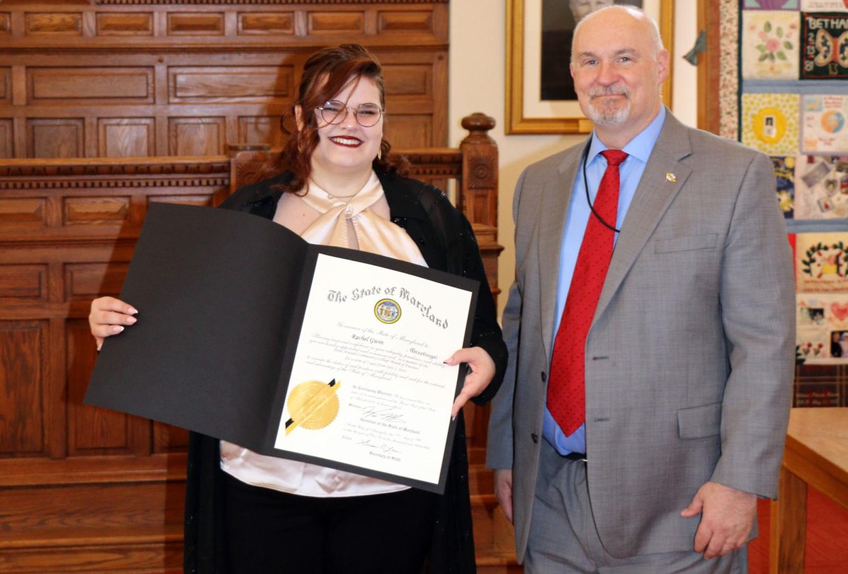 Nursing and emergency medical technician student Rachel Gwin, left, is a voting member of AACC’s Board of Trustees. Anne Arundel County Clerk of the Circuit Court Scott Poyer swore her in on July 17.