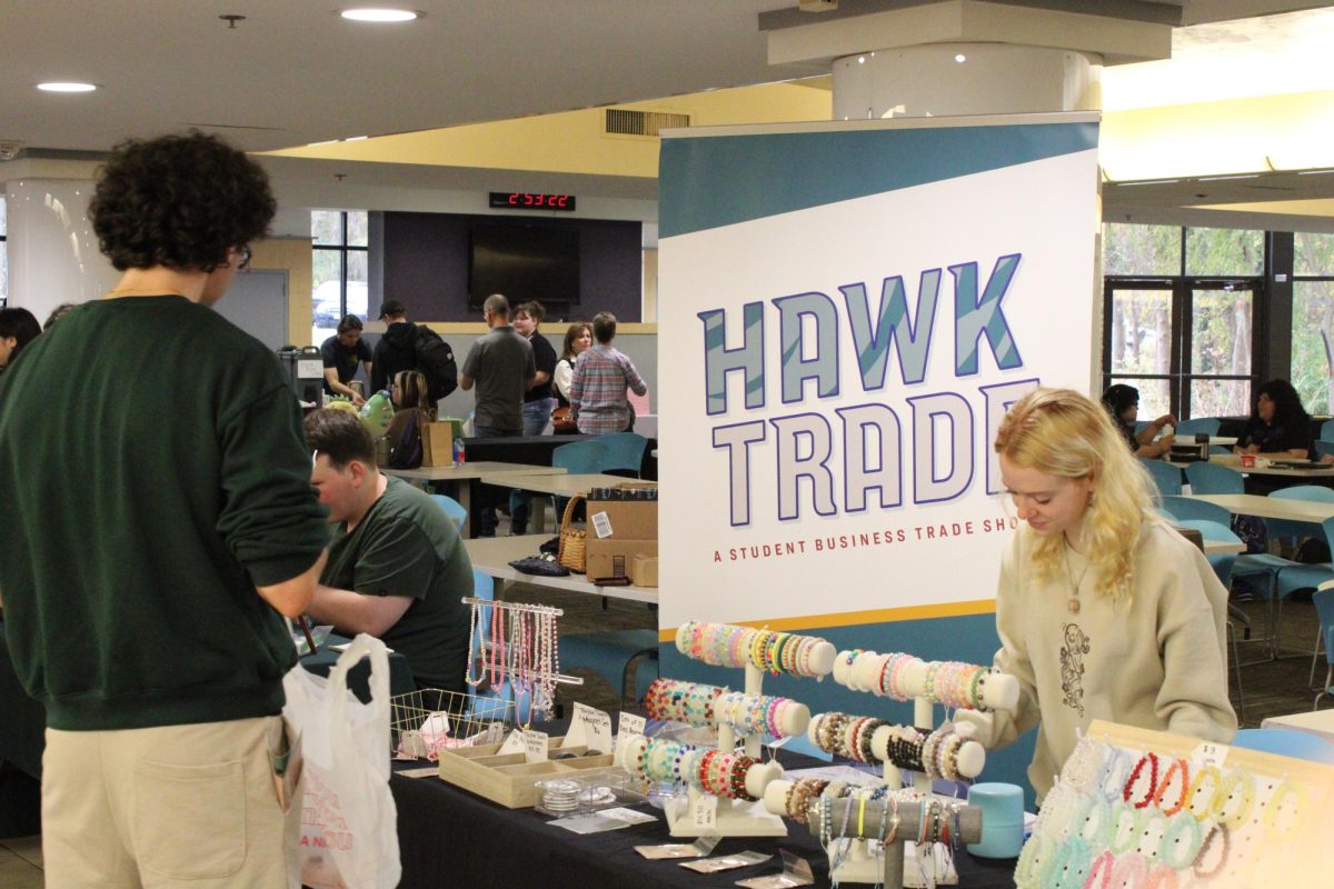 Students buy products from AACC students with their own businesses at the HawkTrade event. 