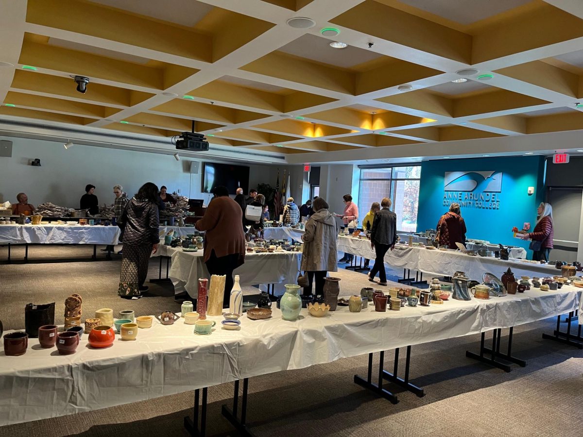 Students, faculty, staff and community members buy handmade pottery at the Ceramics Clubs annual holiday sale on Monday.