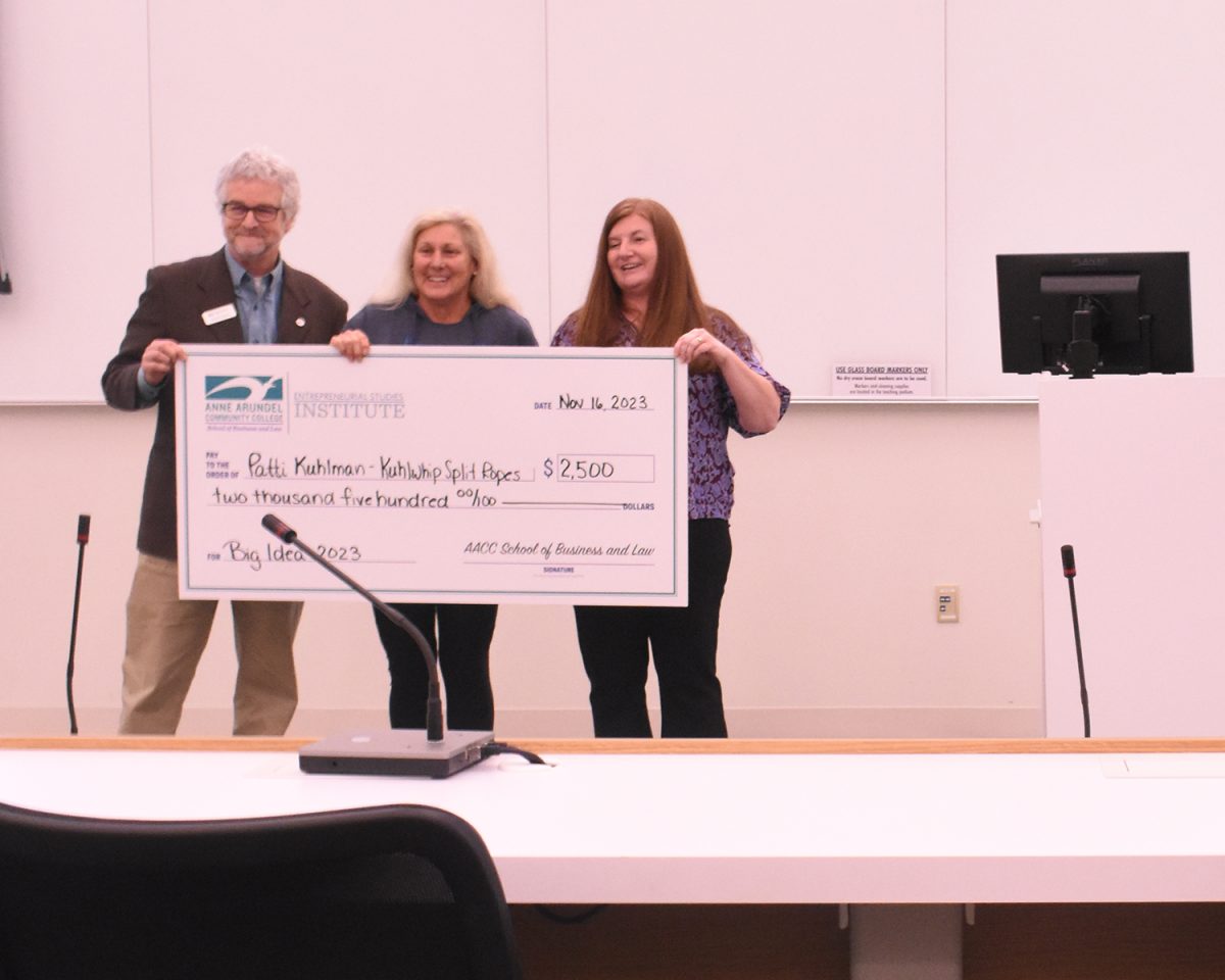 Entrepreneurship student Patti Kuhlman (center), hugs Entrepreneurial Studies Institute Chair Stephanie Goldenberg after winning $2,500 for a “big idea.”