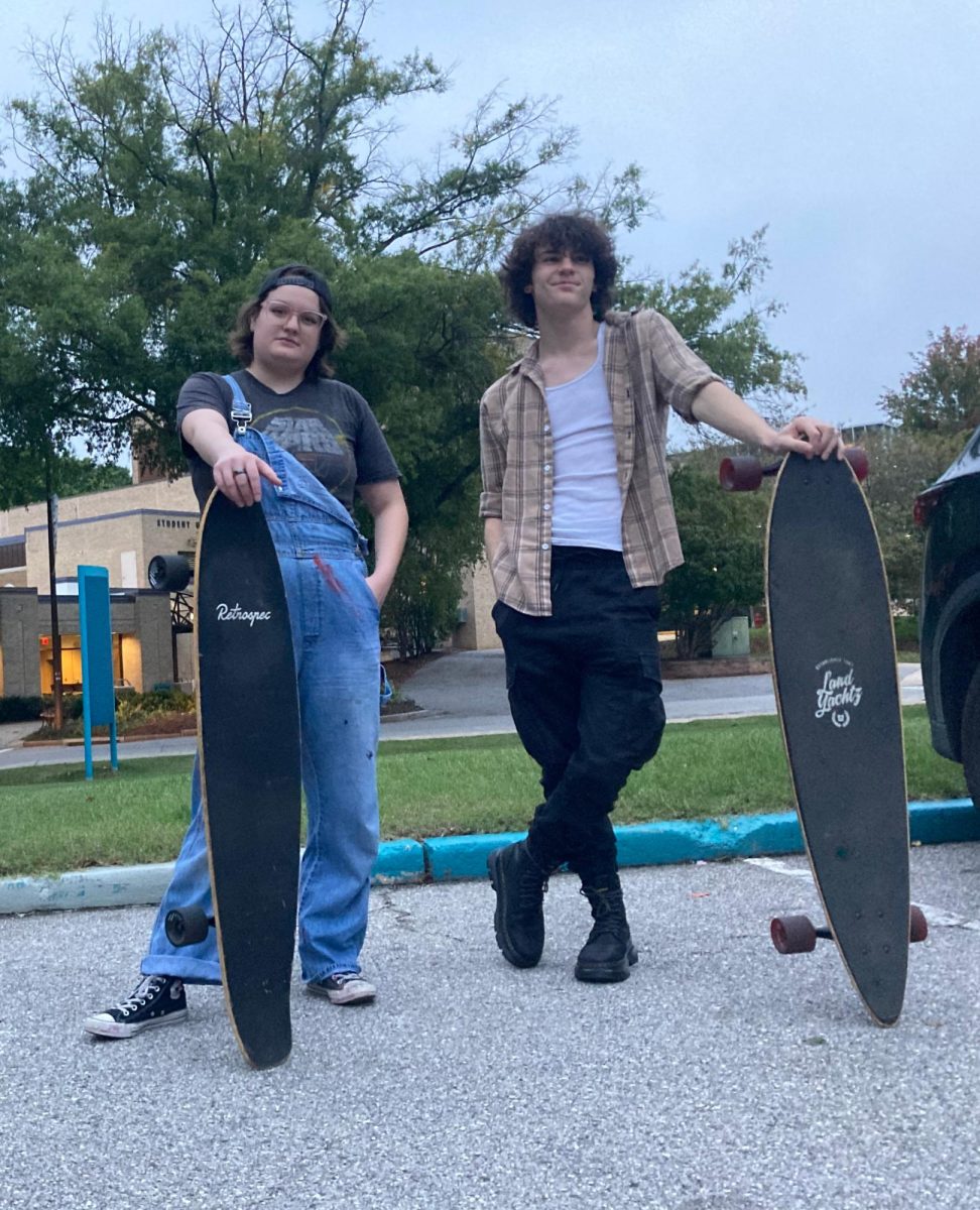 Second-year production design student Gabby Bly, left, and first-year student Joseph Beard both use longboards to get around campus.