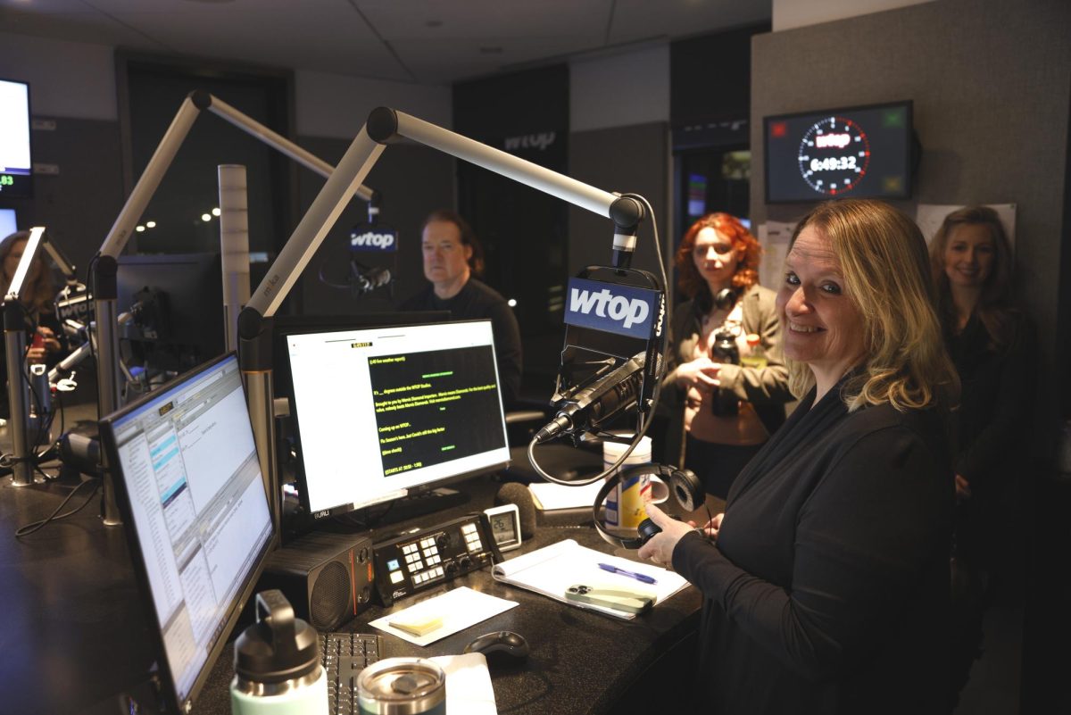 Students tour WTOP Radio, the largest news radio station in the country, during a Campus Current field trip. Foreground, WTOP anchor Anne Kramer with AACC students.