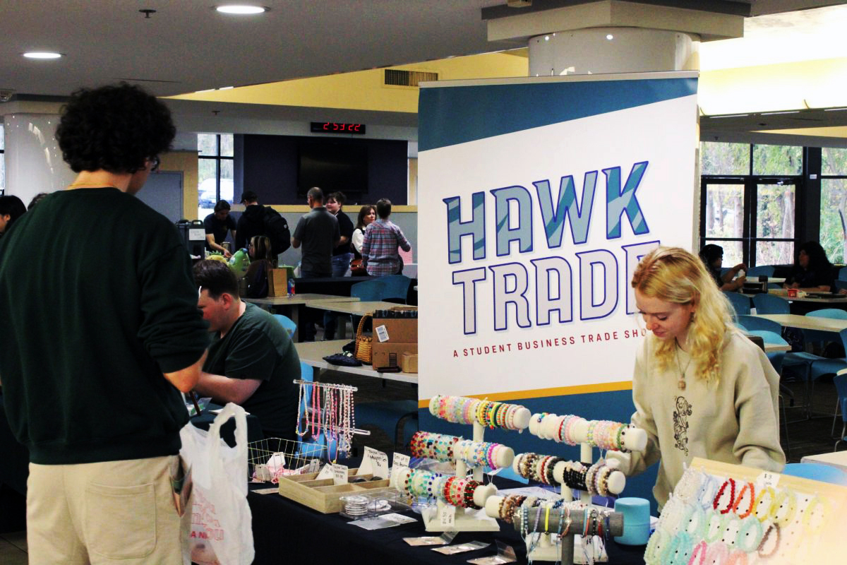 Cameron Hanley, one of the many students at AACC who runs a small business, sells handmade jewelry at a student business fair.