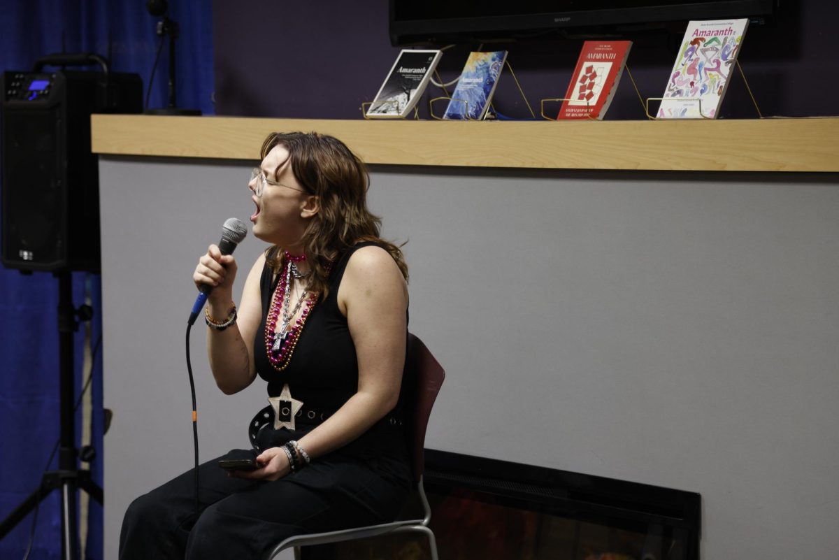 Zoë Sharp performs at an Amaranth open mic night. 