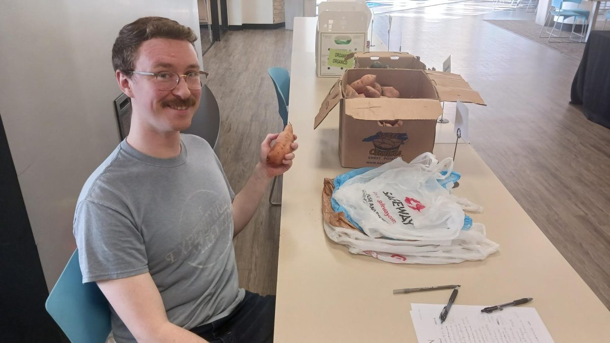 Basic needs and student engagement assistant Andrew Barzal, a first-year human service student, gave out free farm produce to students at the event.