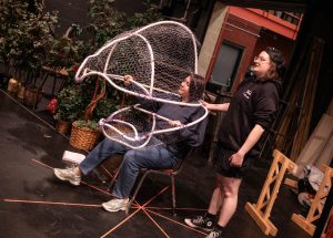 Second-year theater and production design student Gabby Bly, right, designed the Audrey II puppet for Theatre AACC’s spring performance of “Little Shop of Horrors.”

