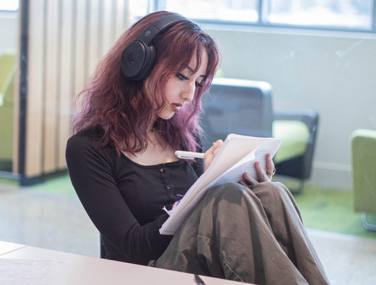 Heena Cook, a second-year graphic web design student, listens to music while studying.