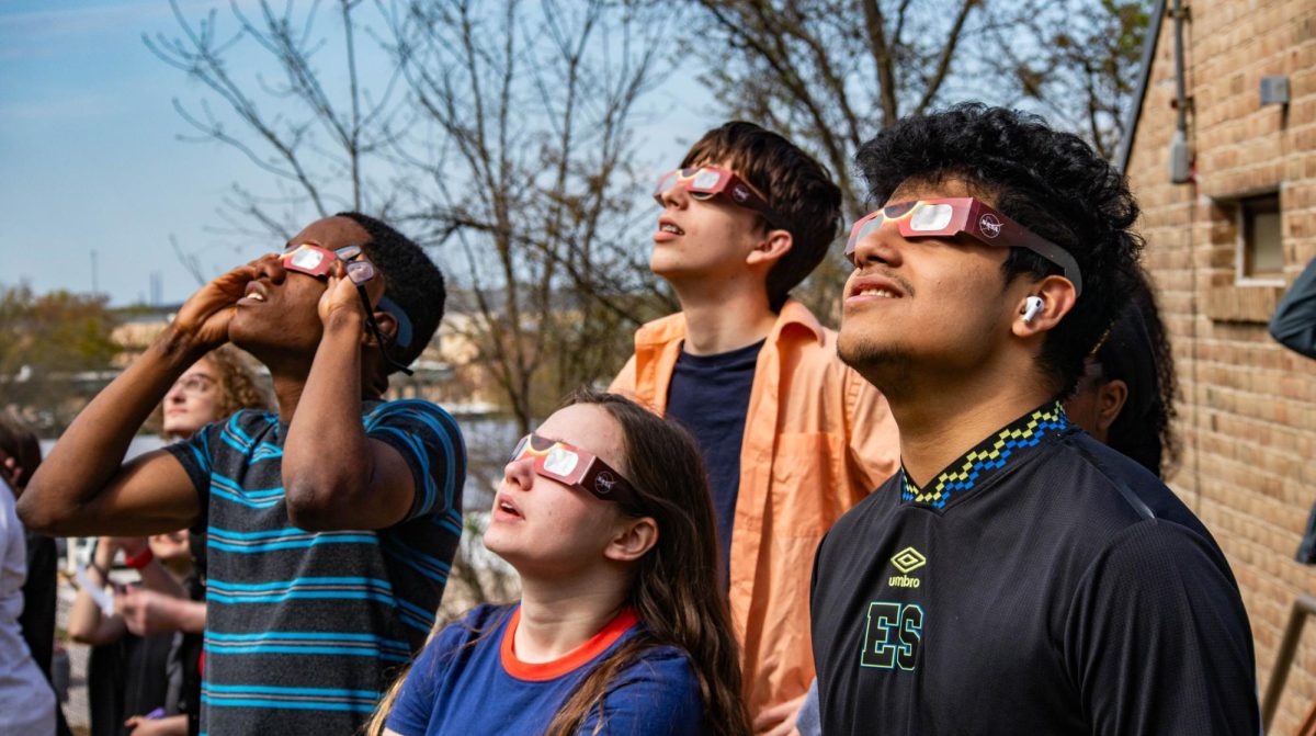 AACC students watch the solar eclipse on Monday using special glasses to protect their eyes.