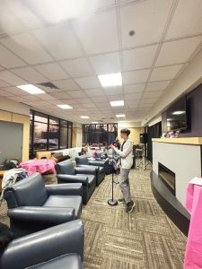 Dual-enrollment student Tomi Brunton, a former Campus Current editor, sets up for an open mic night hosted by Amaranth, the student arts journal.