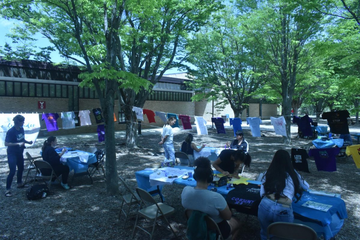 Students designed T-shirts in the Quad for a Clothesline Project event. 
