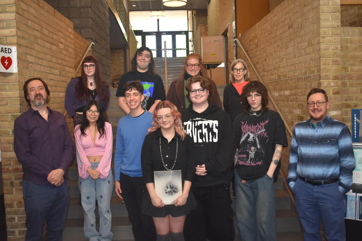 The staff and faculty advisers for Amaranth, AACC’s student journal for the arts, pose with the magazine’s 1984 edition.