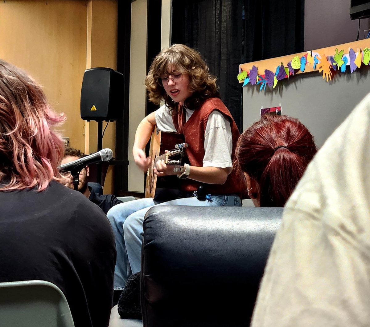 Mackenzie Bridgeman, a cybersecurity student, performs during an open mic night hosted by Amaranth, AACC's student journal of the arts.